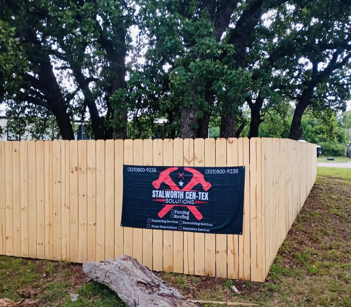 Wood privacy fence — stalworth job-site banner